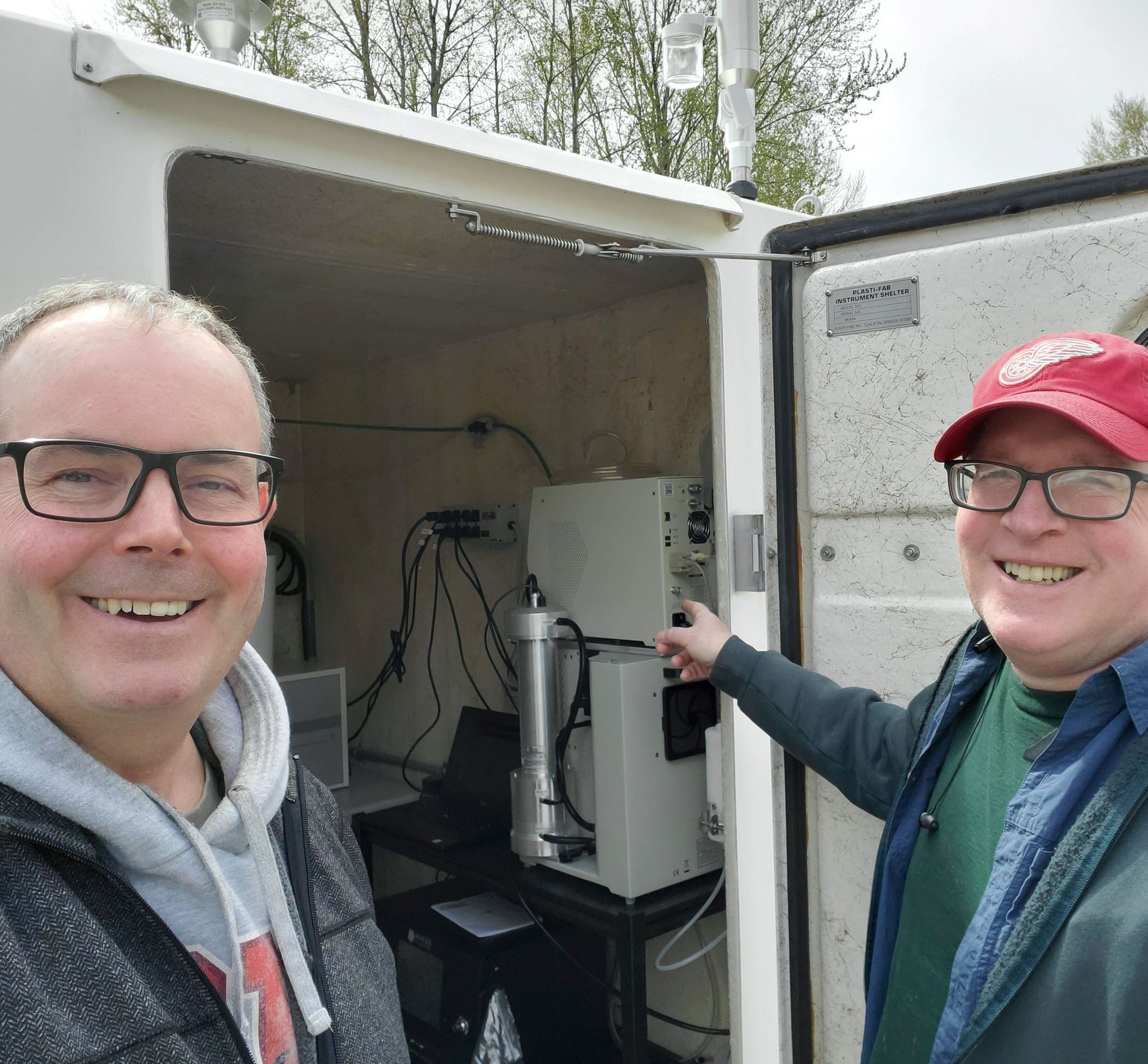 Matt Harper giving a tour of the new SeaTac airport monitoring station to Des Moines City Council member, JC Harris	