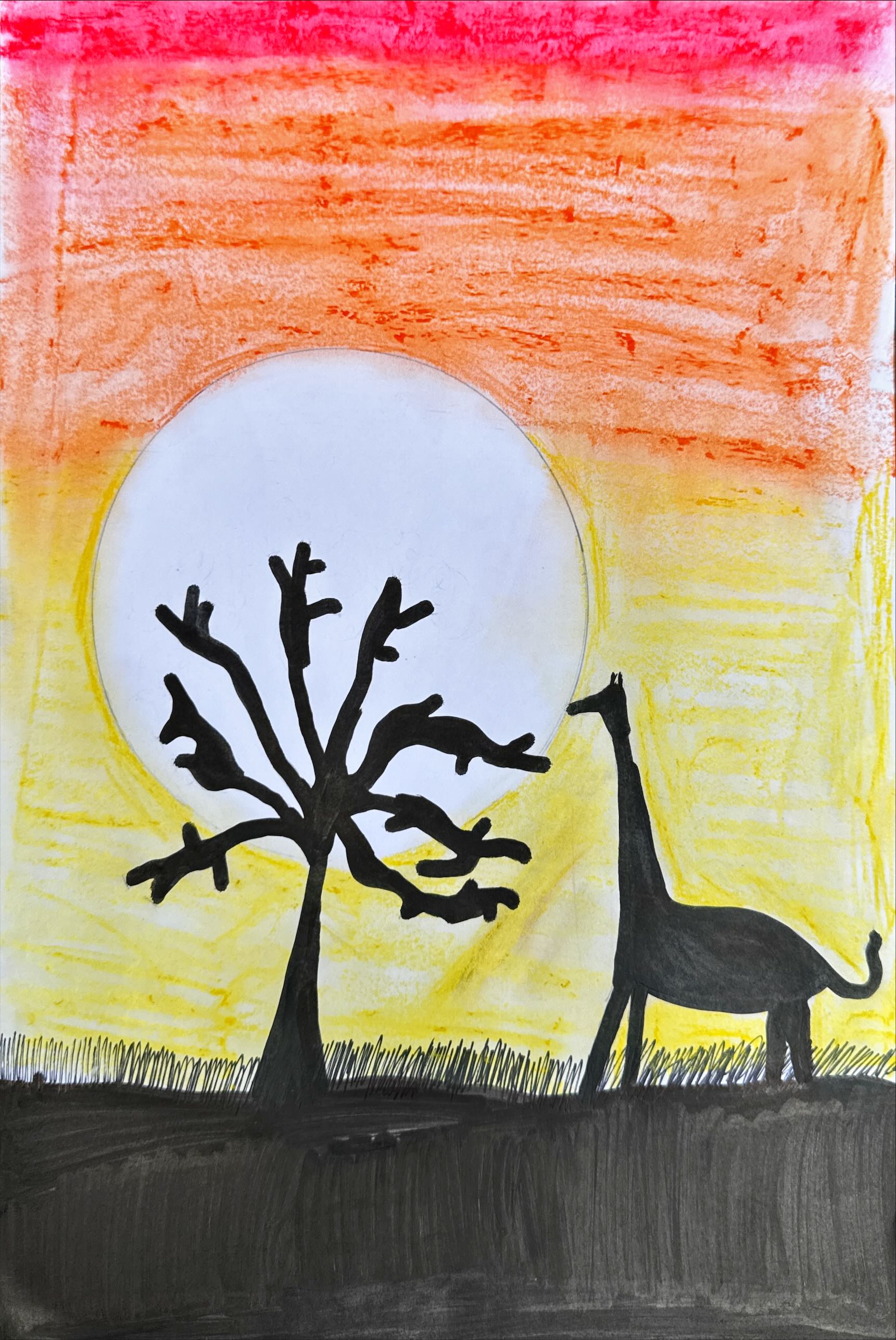 Giraffe and tree silhouette against a sunset